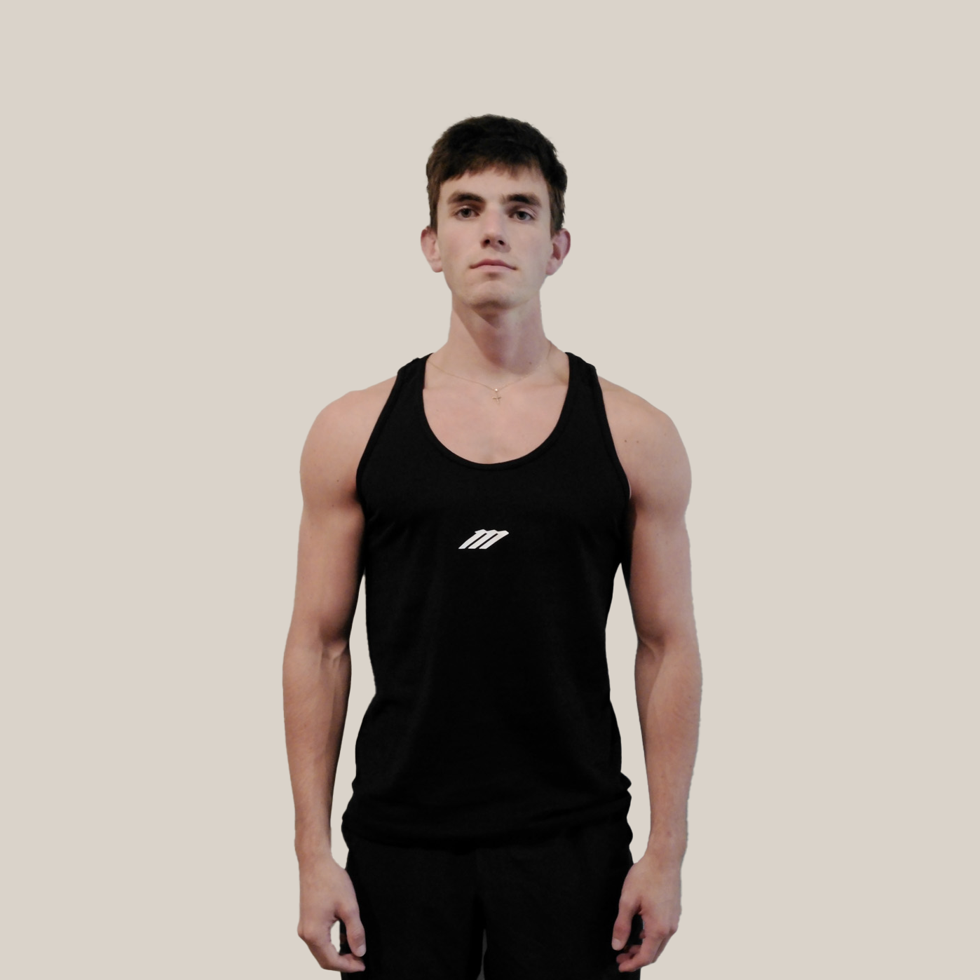 Person wearing a black tank top with a Motion logo on a beige background