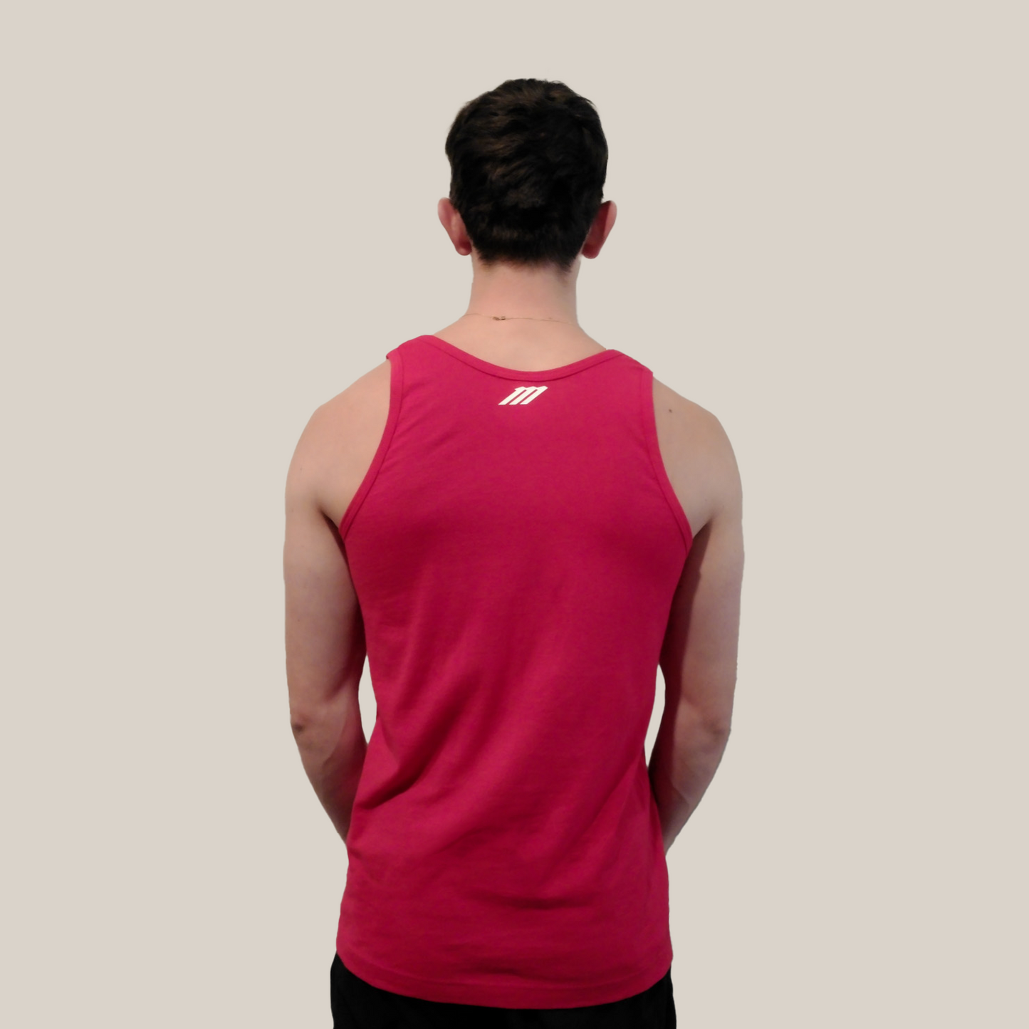 Person wearing a red tank top with a Motion M logo on the back against a beige background