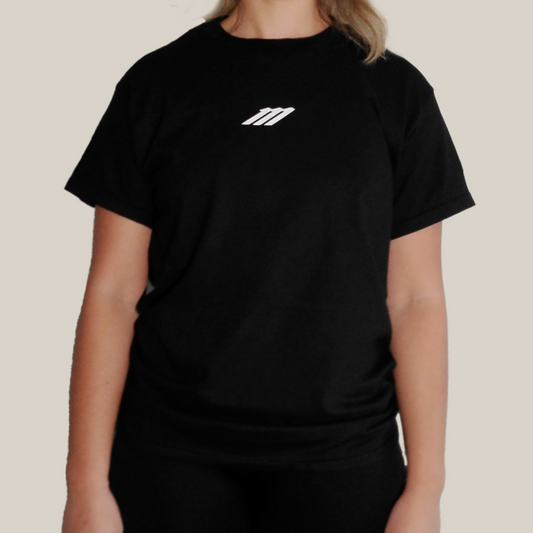 Person wearing a Motion black t-shirt with a logo on a beige background