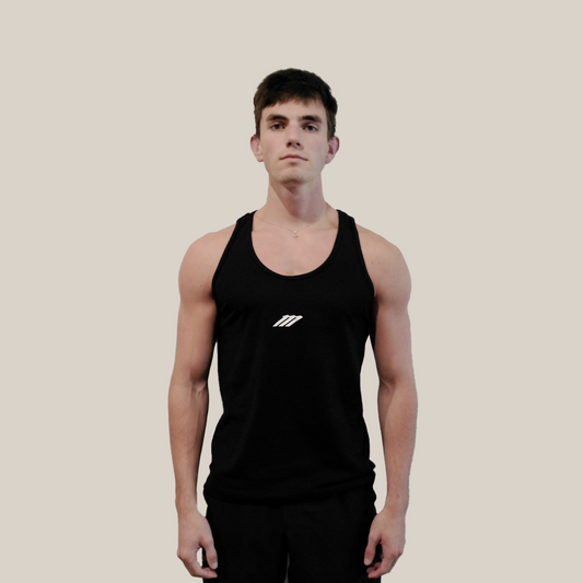 Person wearing a black tank top with a Motion logo on a beige background