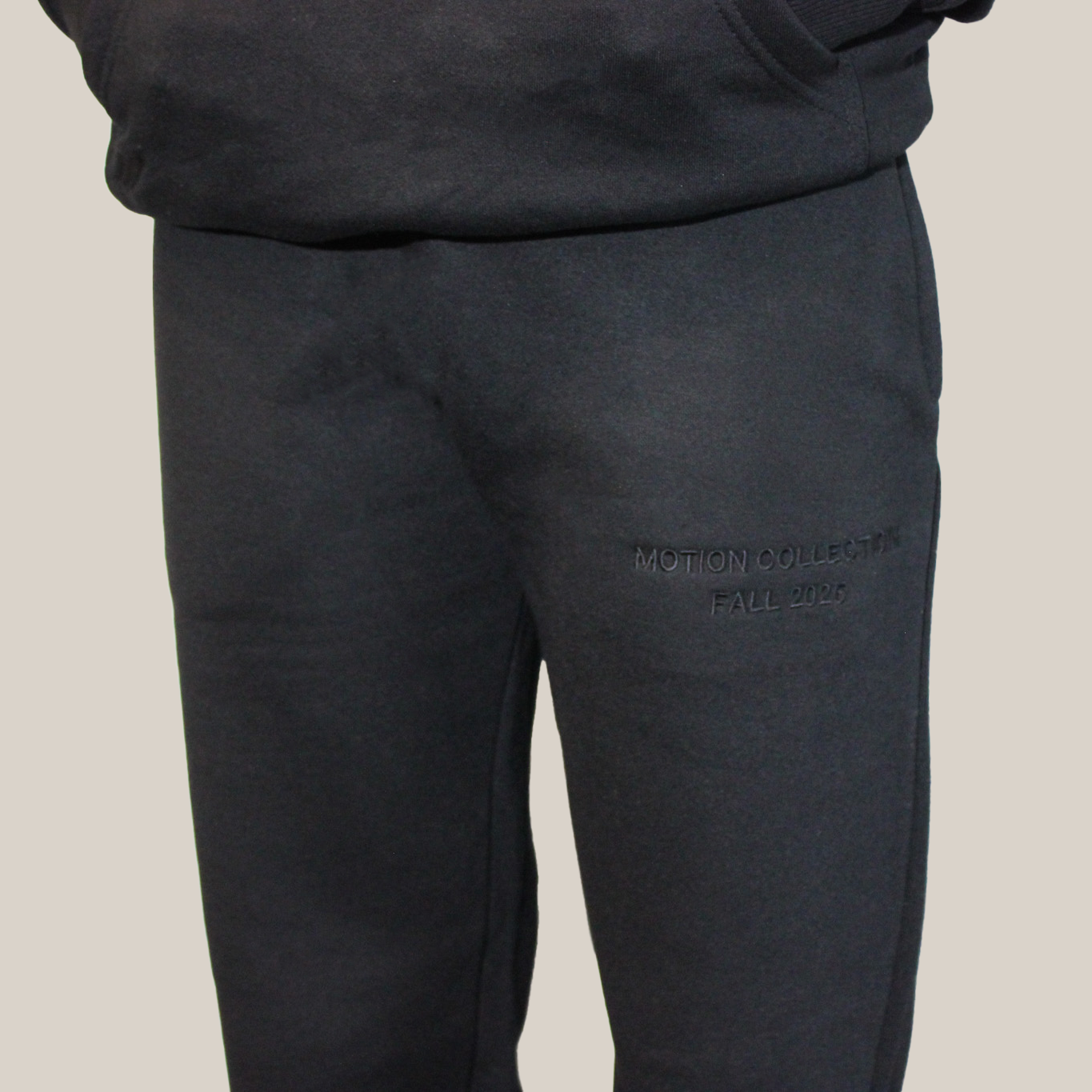 Dark black signature Motion pants with a brand logo on a light background