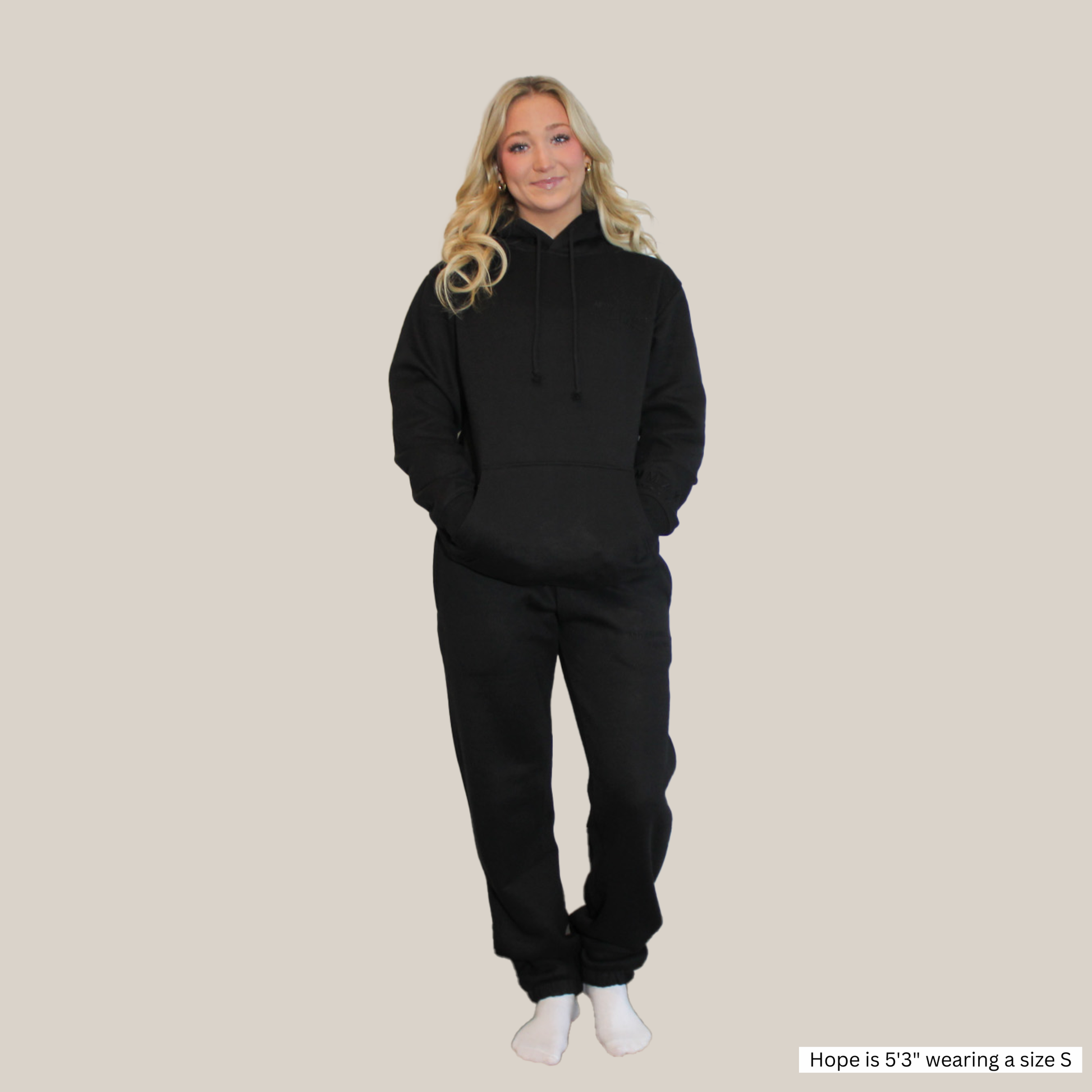 Model wearing a Motion Signature Black Pants and signature motion hoodie